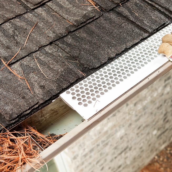 Gutter cap partially installed on a gutter.